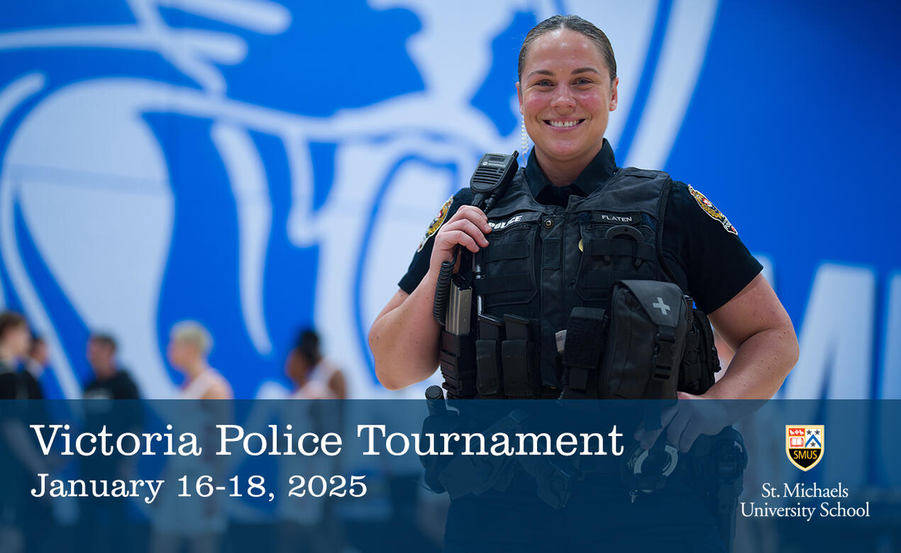 Jaclyn Flaten '03 smiles at the camera in police uniform with the SMUS gym in the background