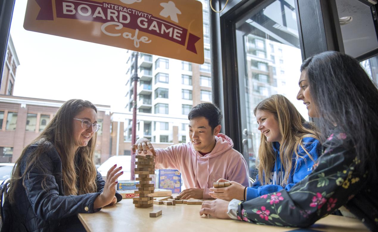 Boarding students enjoying a game of Jenga at the Board Game Café