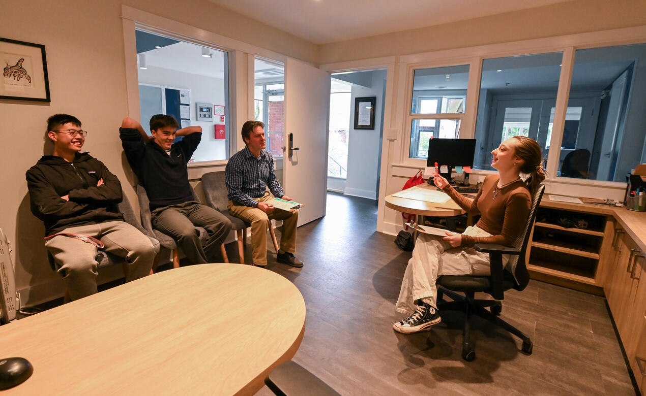 Students gather in the houseparents' office for check-in