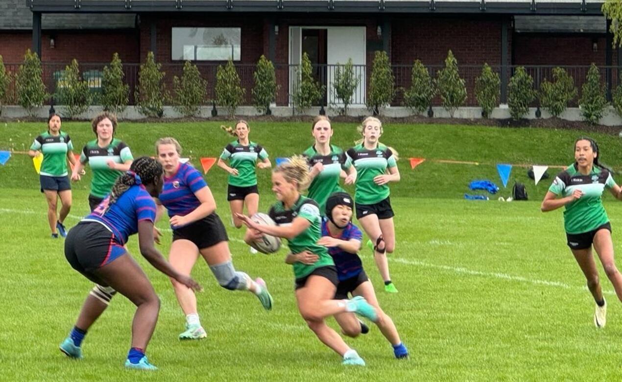 SMUS rugby defends an Oak Bay rugby player during Alumni Weekend on campus