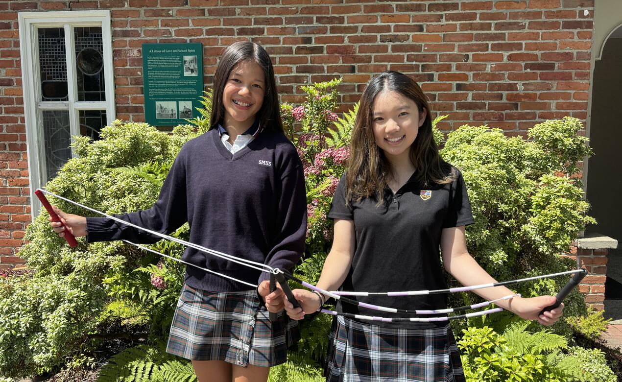 Addy Newman-Ting and Anysia Tam pose with their jump ropes outside the SMUS chapel. 