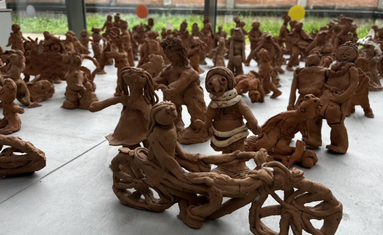 A table full of clay figures from the Reggio-inspired pedagogy.