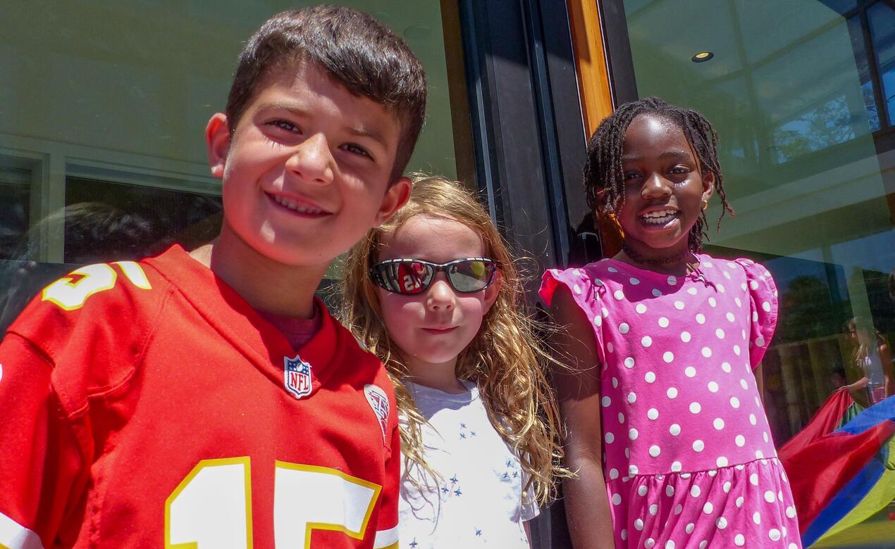 Three day campers smiling at the camera 