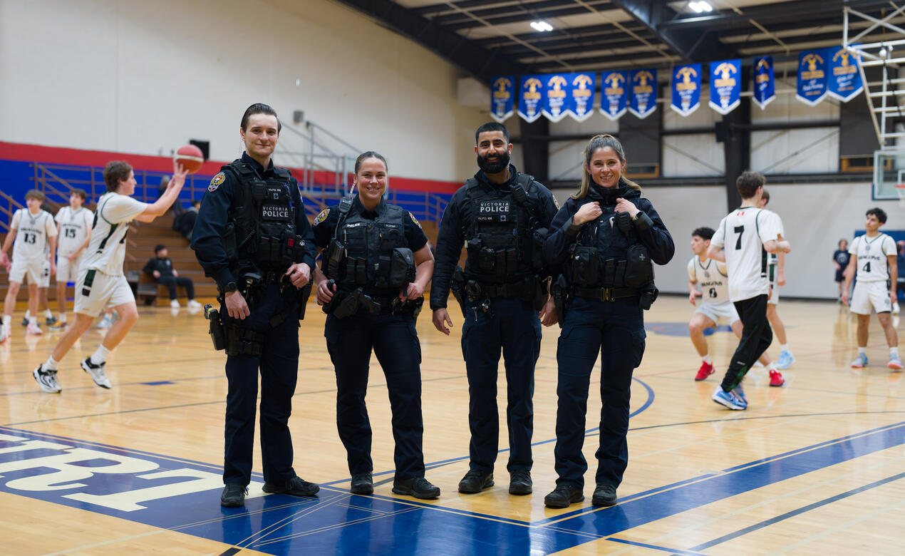 Four police officers smile at the tournament