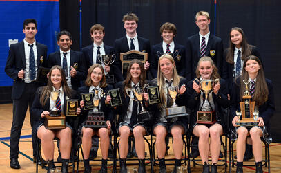 Group photo of Senior School Athletic Awards winners with their trophies