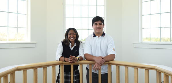 Photo of SMUS students Maya and Aiden leaning on a railing in the bell tower building.