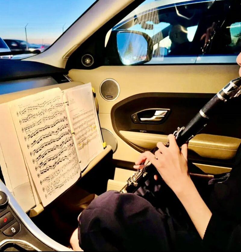Matty Angus practices clarinet while in the front passenger of his car